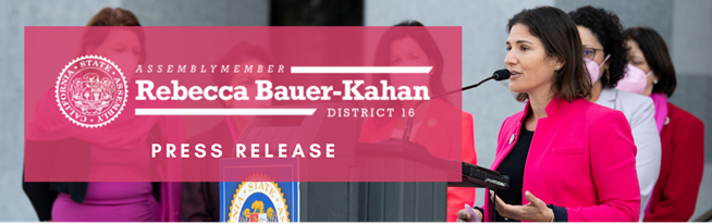 Image of Assemblymember Bauer-Kahan in pink blazer at a microphone. To her side is her logo and the words "press release" in a pink box