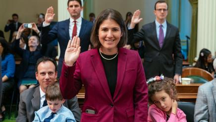 Assemblymember Bauer-Kahan being sworn in at the State Capitol